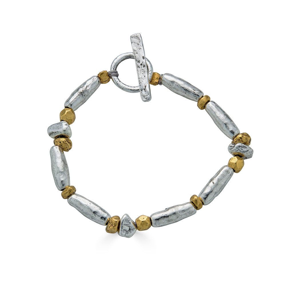 Silver and gold-toned bracelet with mixed metal organic beads and a toggle clasp.