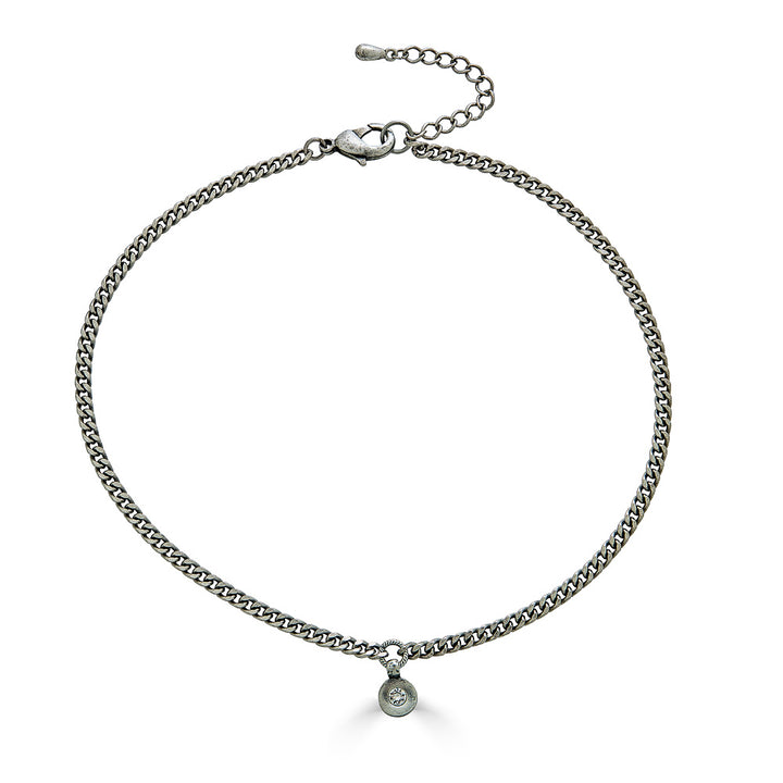 A delicate silver necklace with a small modern crystal pendant.