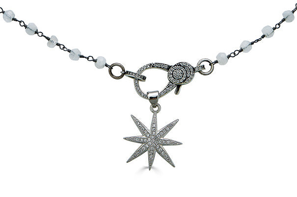 A moonstone gemstone necklace with pave clasp and star pendant.