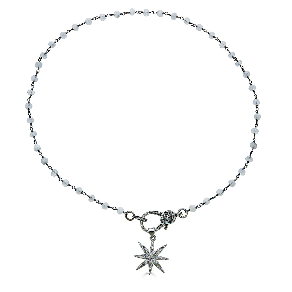 A moonstone gemstone necklace with pave clasp and star pendant.