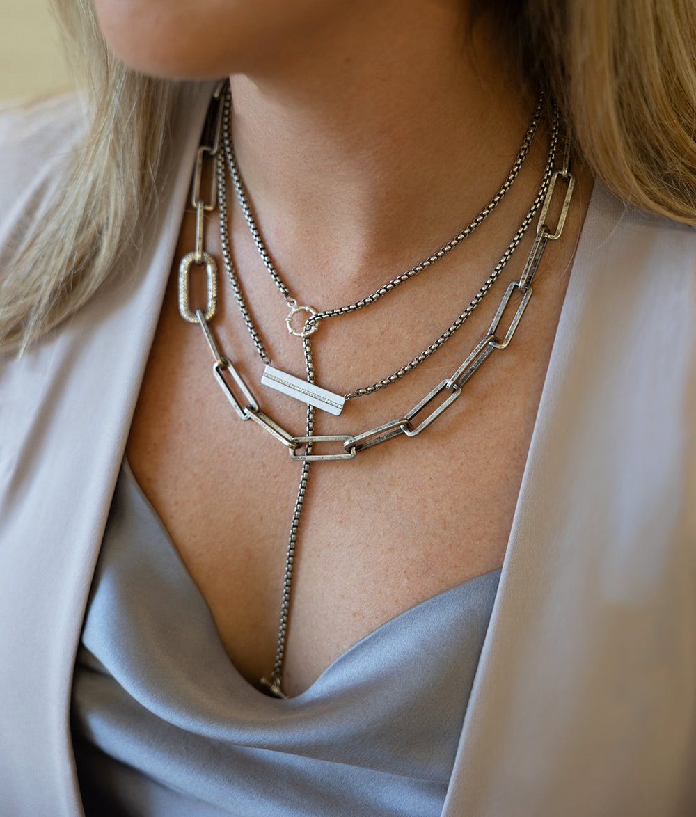 A silver bar with CZS venetian box chain necklace.