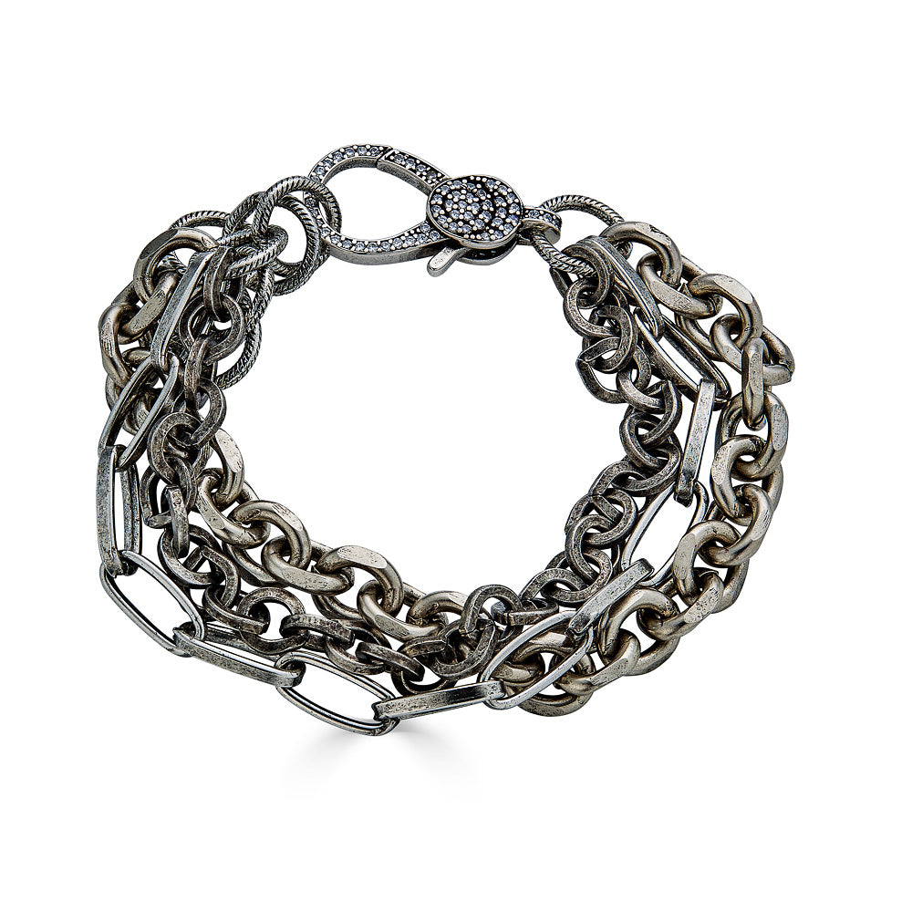 A three strand silver bracelet with pave lobster clasp.