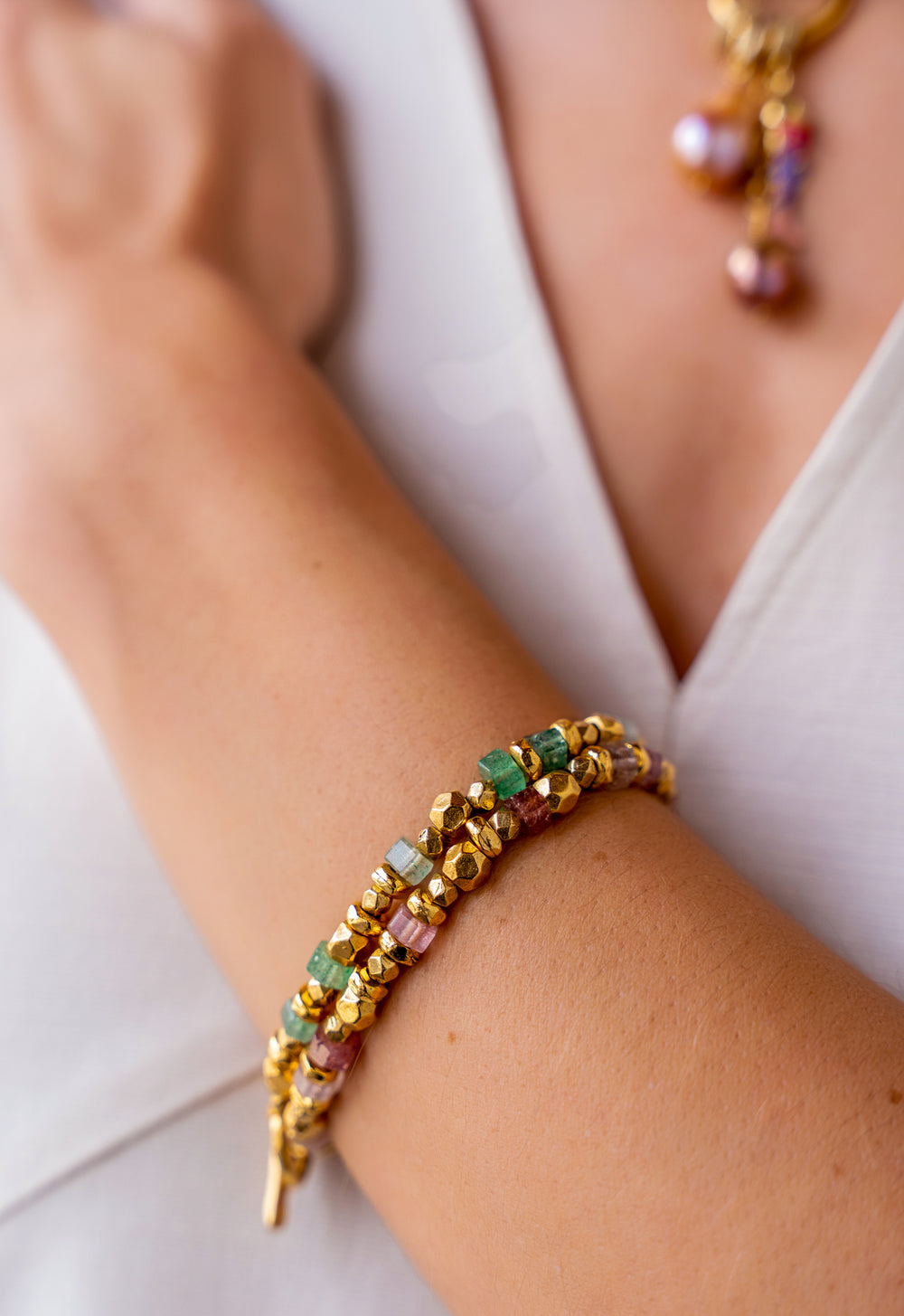 Pink strawberry quartz and gold bead bracelet with organic textured beads and toggle clasp.