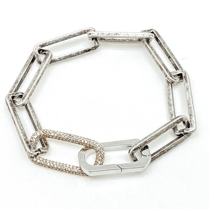 A silver paperclip chain bracelet with pave link detail.