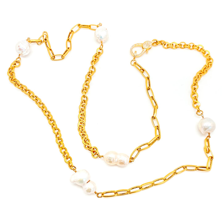 A baroque pearl gold chain necklace with pave clasp.
