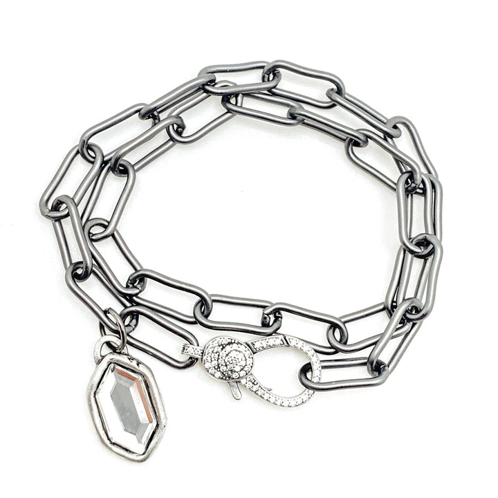 A double wrap silver paperclip chainlink bracelet with a marquis charm.