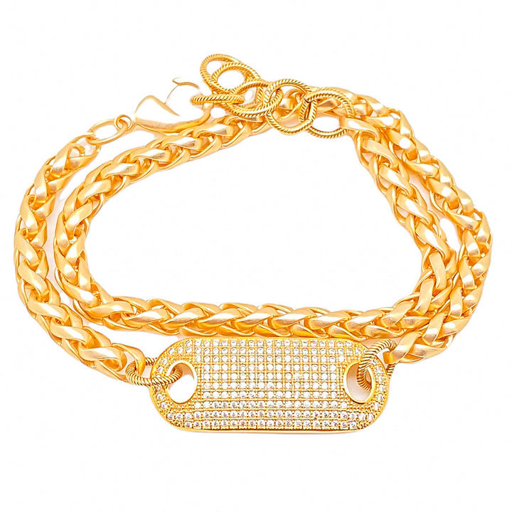 A double wrap matte gold bracelet with pave connector. 