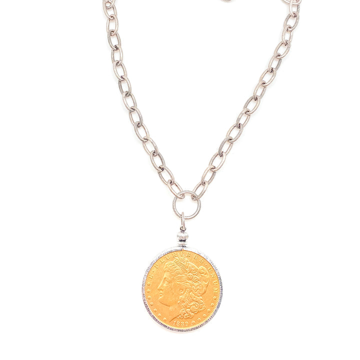 A vintage gold coin pendant necklace with silver chain.