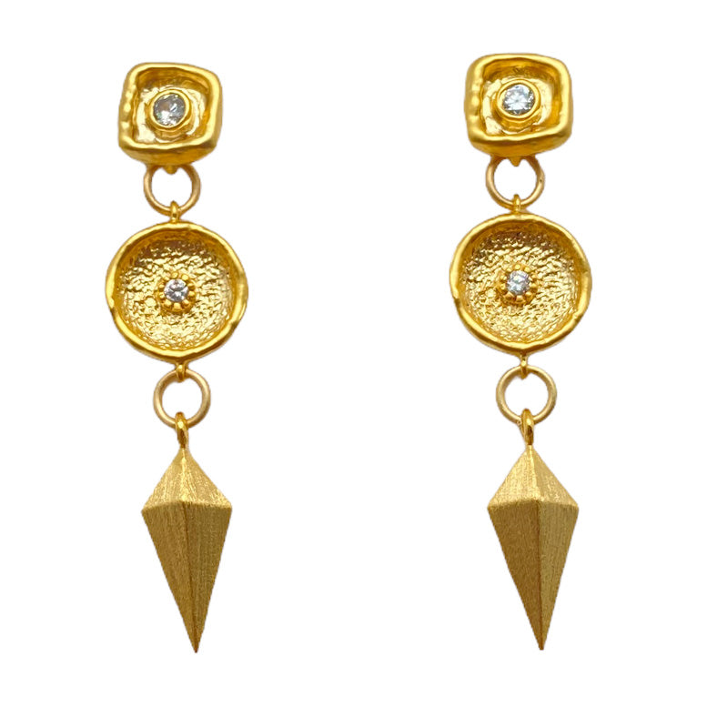 A matte gold dangle earring with a shield charm and a crystal connector.  Post earrings with a crystal detail