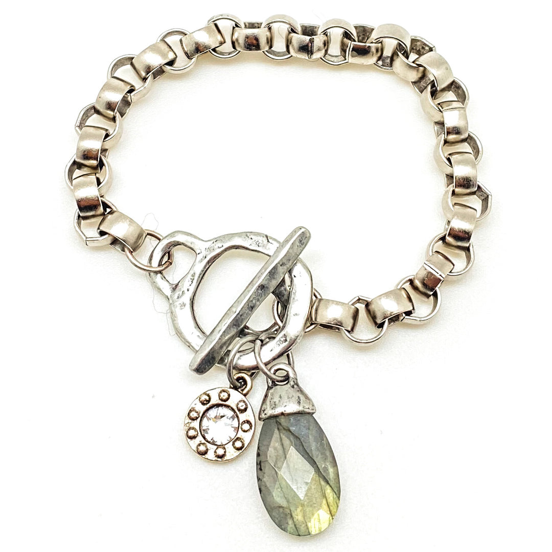 A silver chunky rolo chain bracelet with a labradorite charm and toggle clasp.