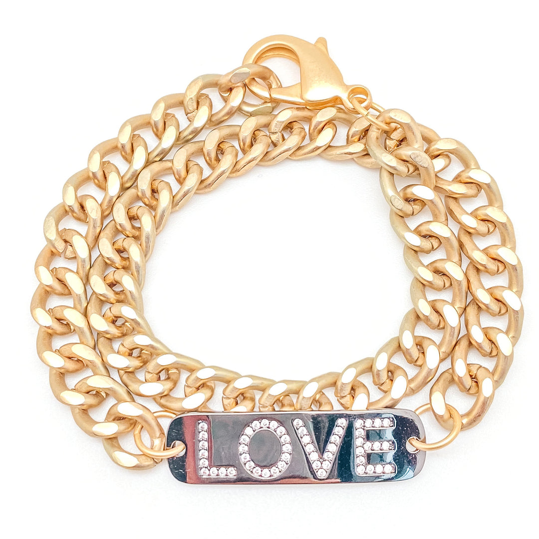 A matte gold chainlink bracelet with LOVE in CZS on silver tag.
