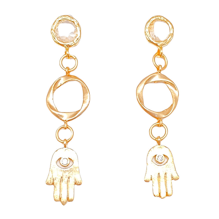 A pair of matte gold hamsa earring with circle connectors and crystal posts.