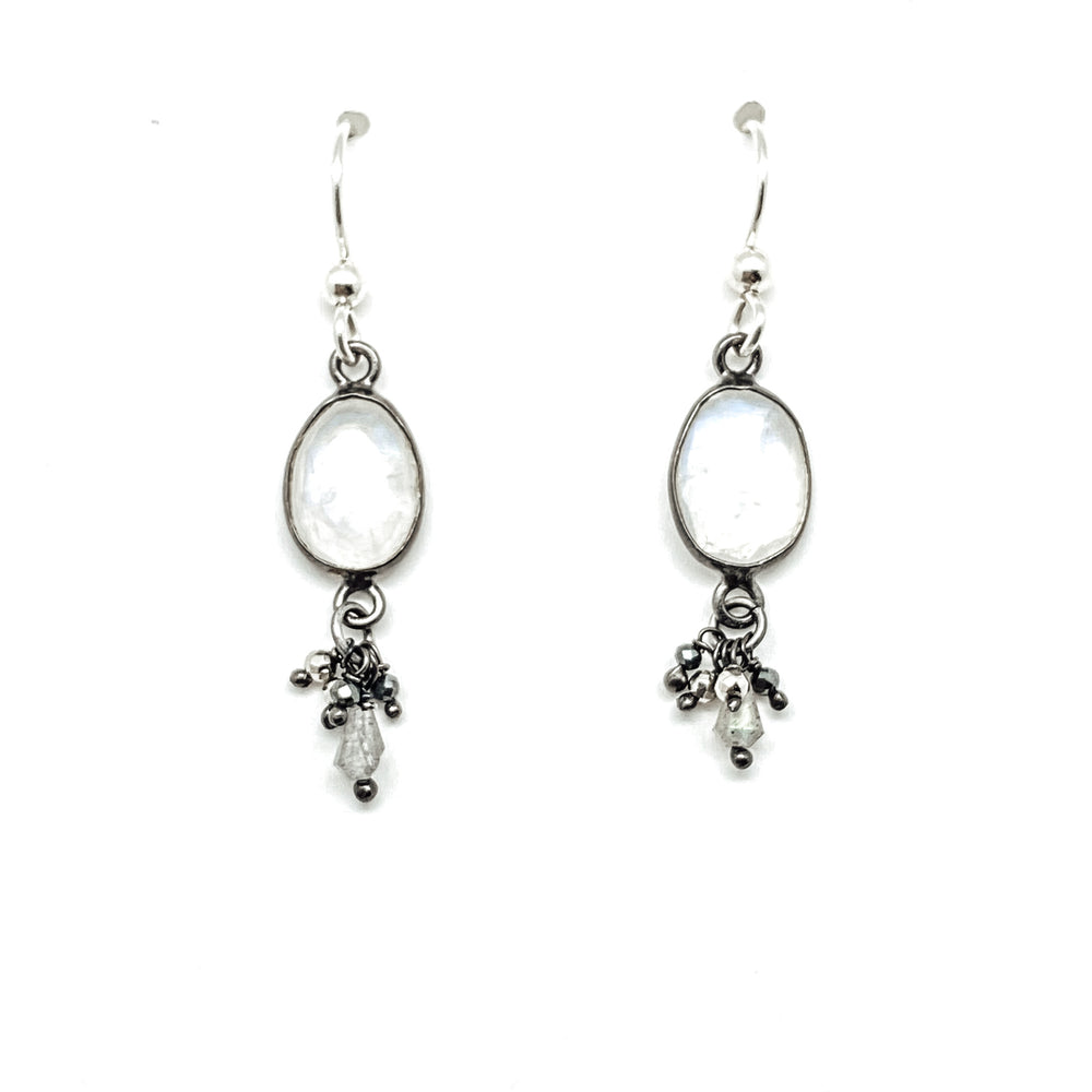A pair of silver moonstone drop earrings with drizzle details.