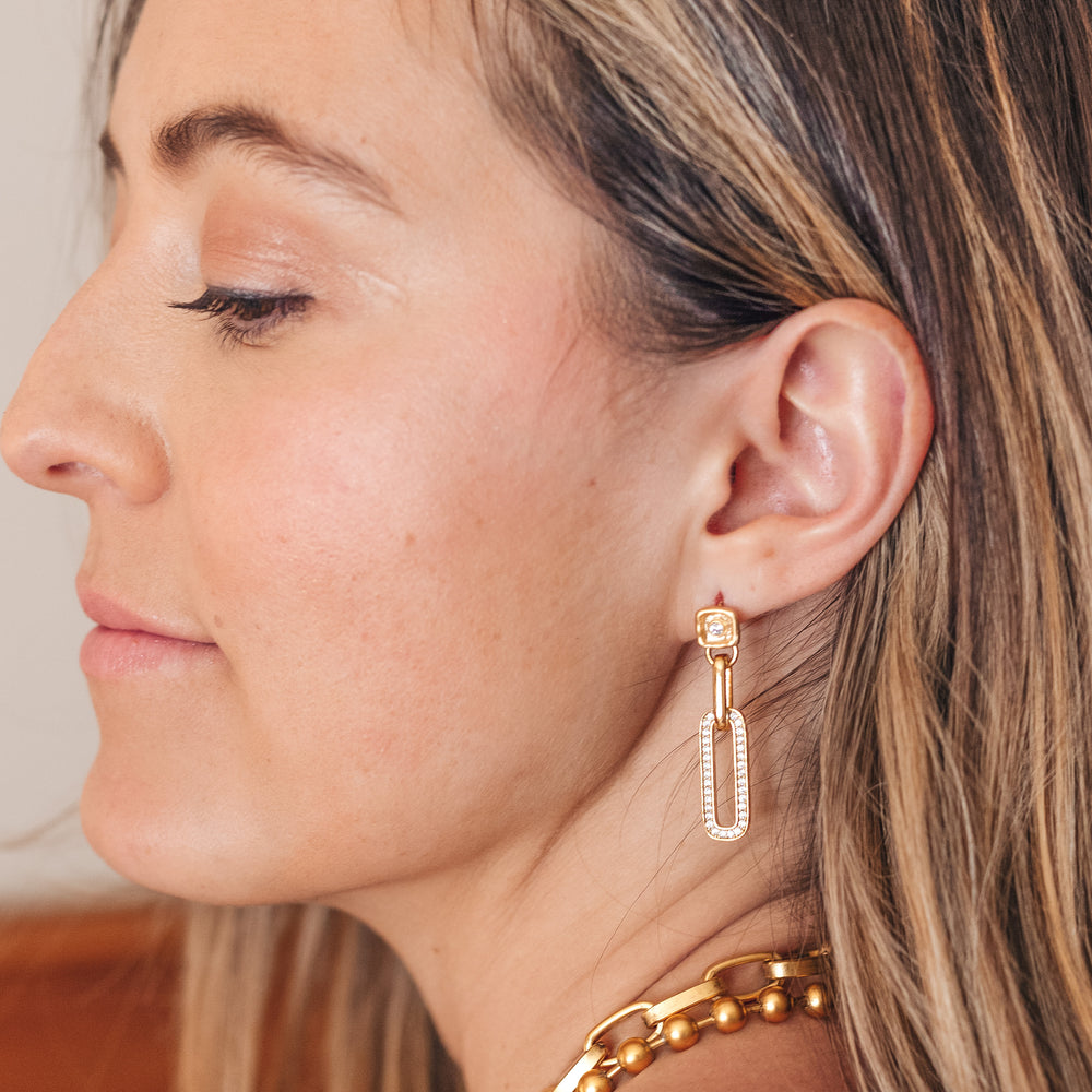 A woman modeling a pave drop crystal earring.