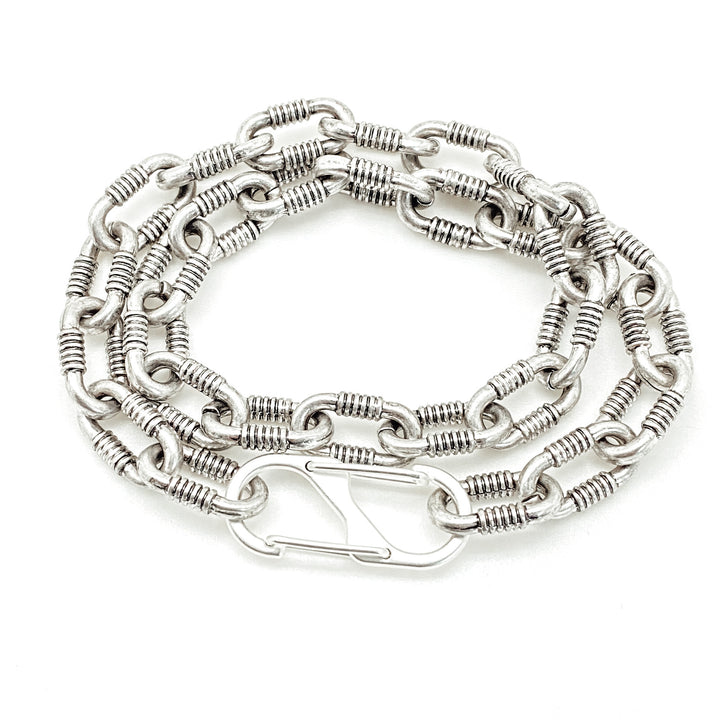 A silver double wrap chunky chainlink bracelet with a snap clasp.
