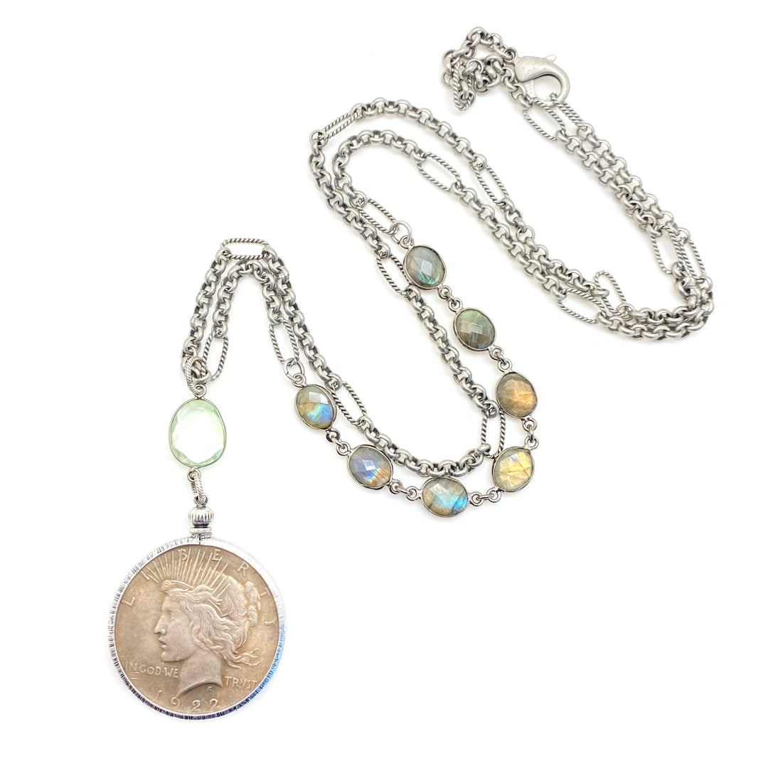 A vintage silver dollar pendant necklace with mixed chainlinks and labradorite gems.