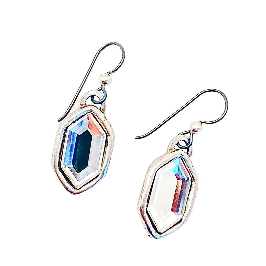 A pair of silver elongated hexagon crystal earrings.