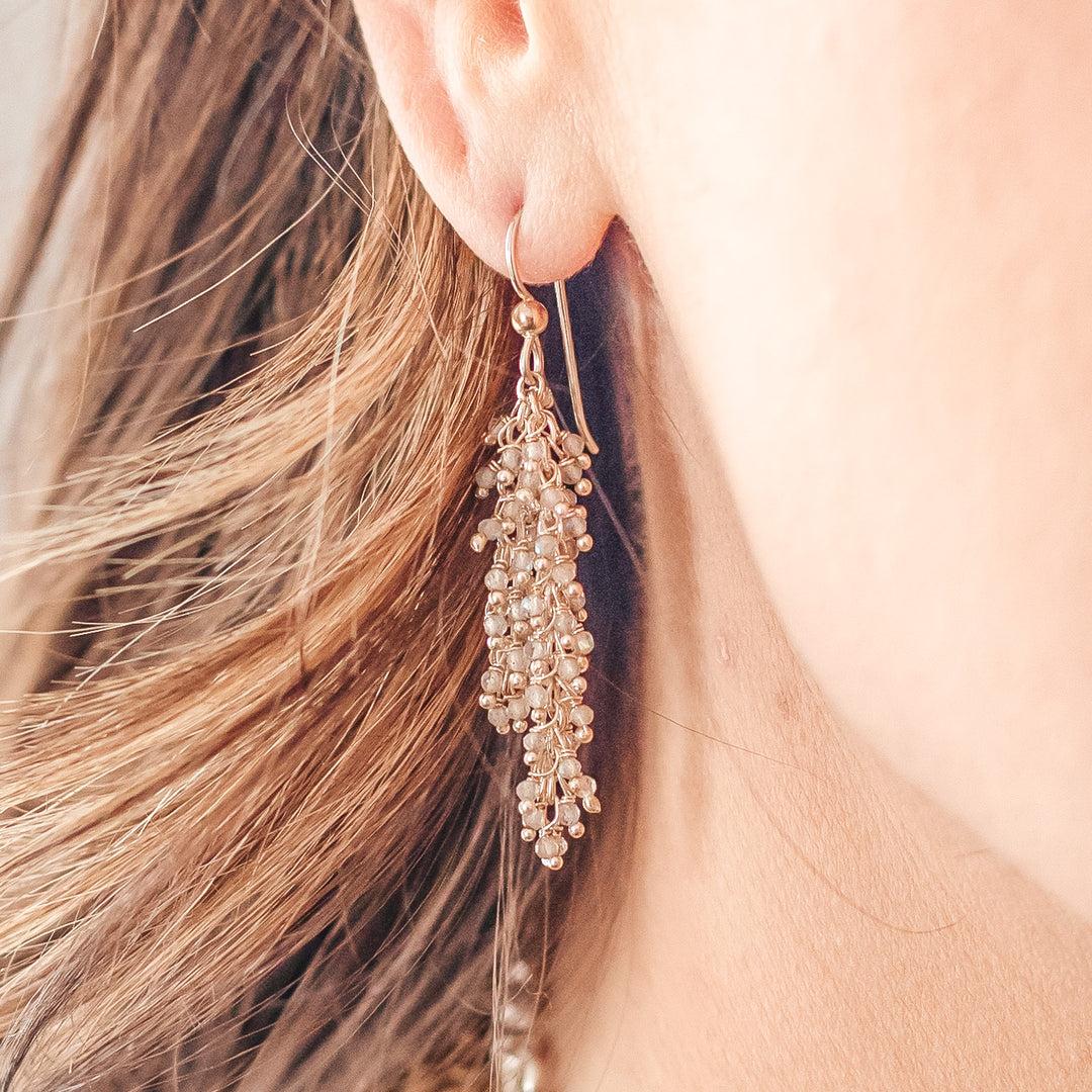 A model wearing a silver labradorite drizzle earring.