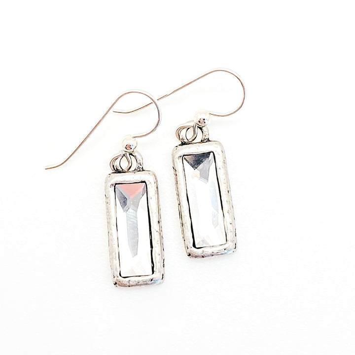 A pair of silver rectangular crystal drop earrings.