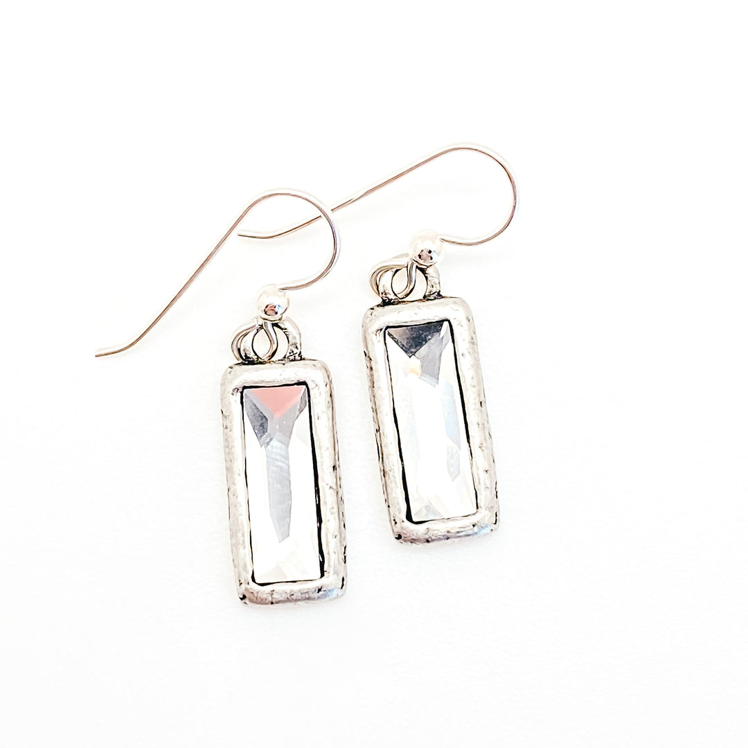 A pair of silver rectangular crystal drop earrings.