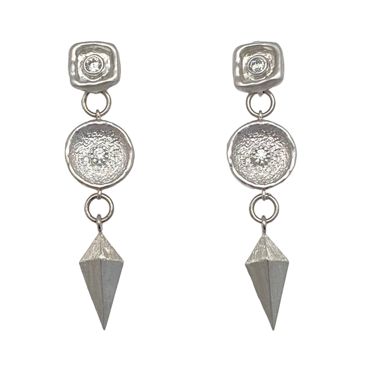 A matte silver dangle earring with a shield charm and a beautiful crystal connector.